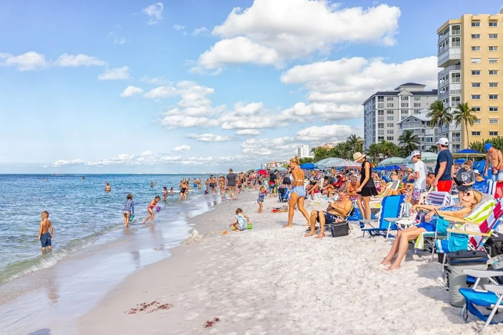 Vanderbilt Beach Crowded with Tourists on the Sand